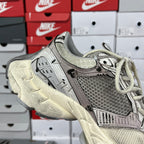 Balenciaga unisex running shoes, angled side view with lace-up front and gray textured panels