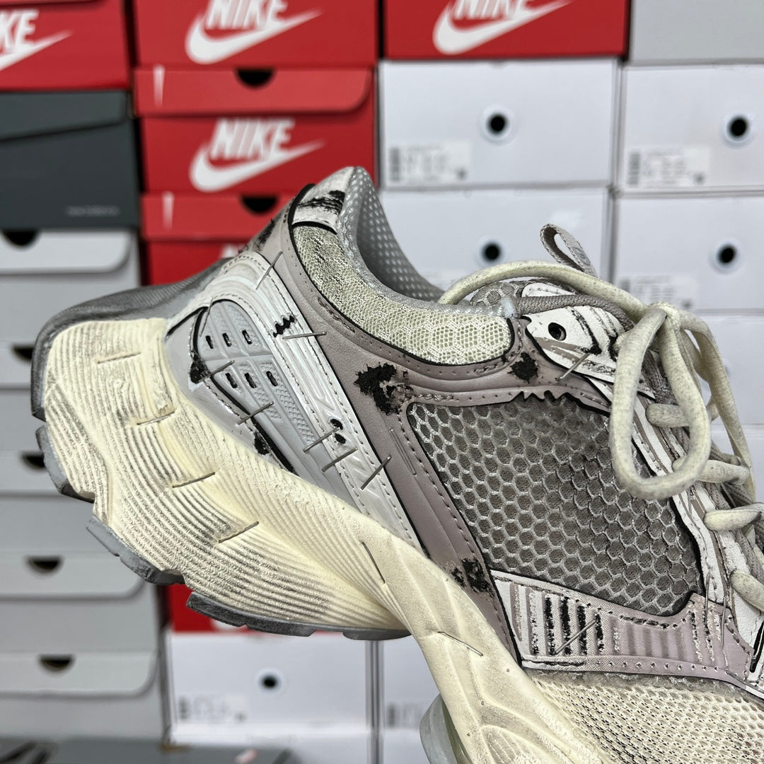 Balenciaga unisex running shoes, angled side view with lace-up front and gray textured panels