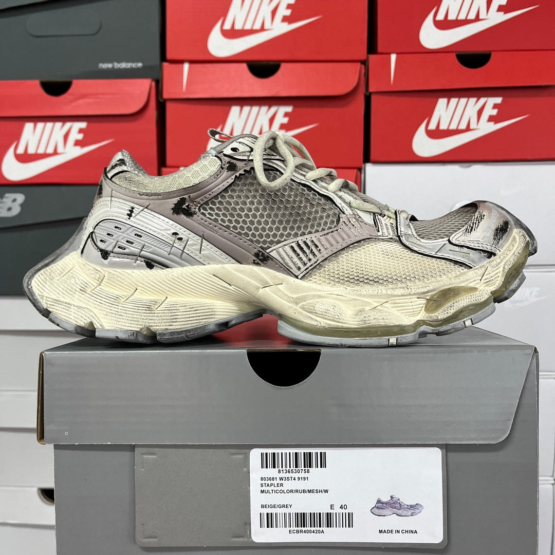 Balenciaga unisex running shoes, side view with gray textured panels and chunky off-white sole