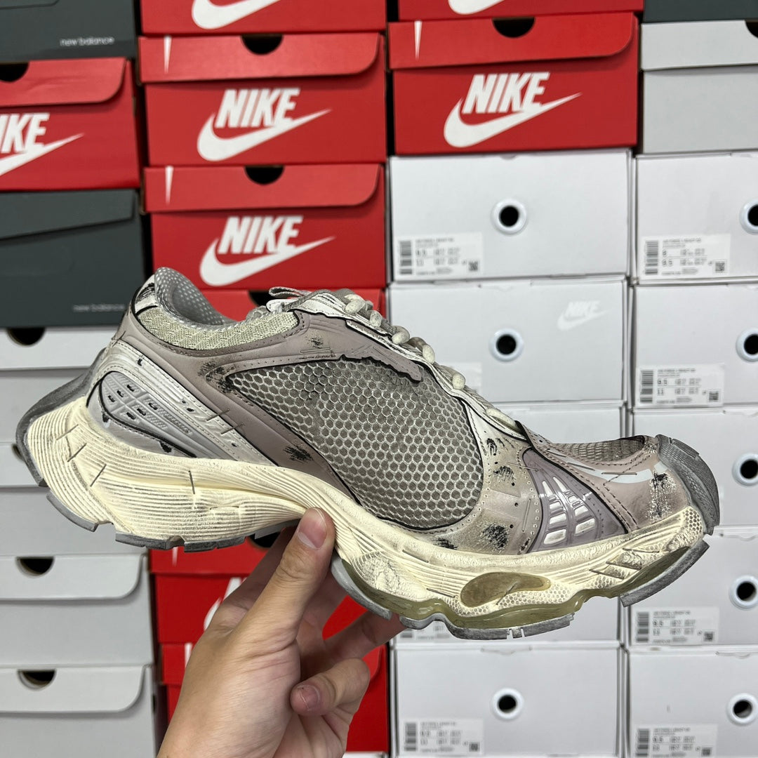 Balenciaga unisex running shoes, front side view with gray mesh upper and off-white midsole