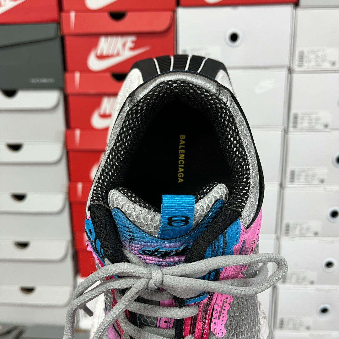 Unisex running shoe tongue and heel, black lining with blue trim, lace-up.