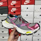 Unisex running shoe, grey mesh with pink and black accents, white sole, lace-up.