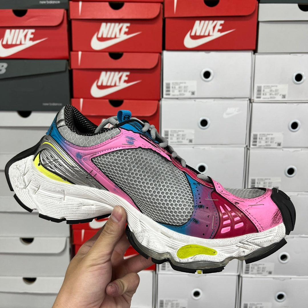 Unisex running shoe, front 3/4 view, grey mesh with pink upper and neon yellow accents.