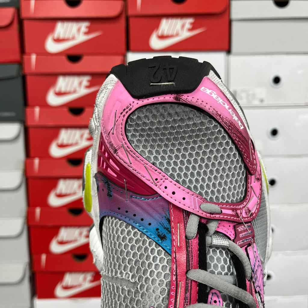 Unisex running shoe upper, grey mesh with pink strap and blue graphic on side.