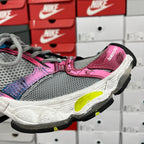 Unisex running shoe side profile, pink and grey upper with neon yellow outsole detail.