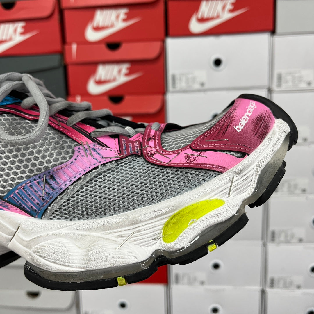 Unisex running shoe side profile, pink and grey upper with neon yellow outsole detail.