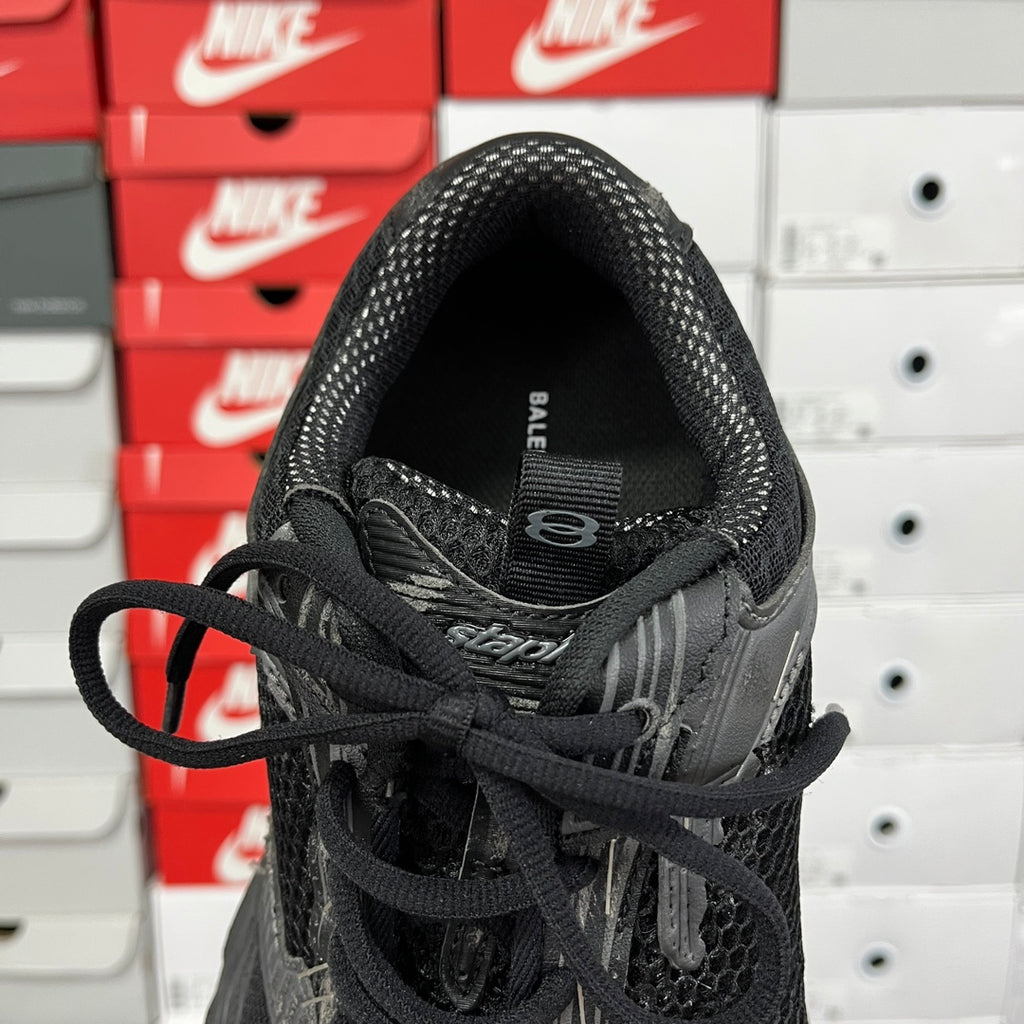 Black mesh sneaker collar with BALENCIAGA logo detail and lace-up front, close-up