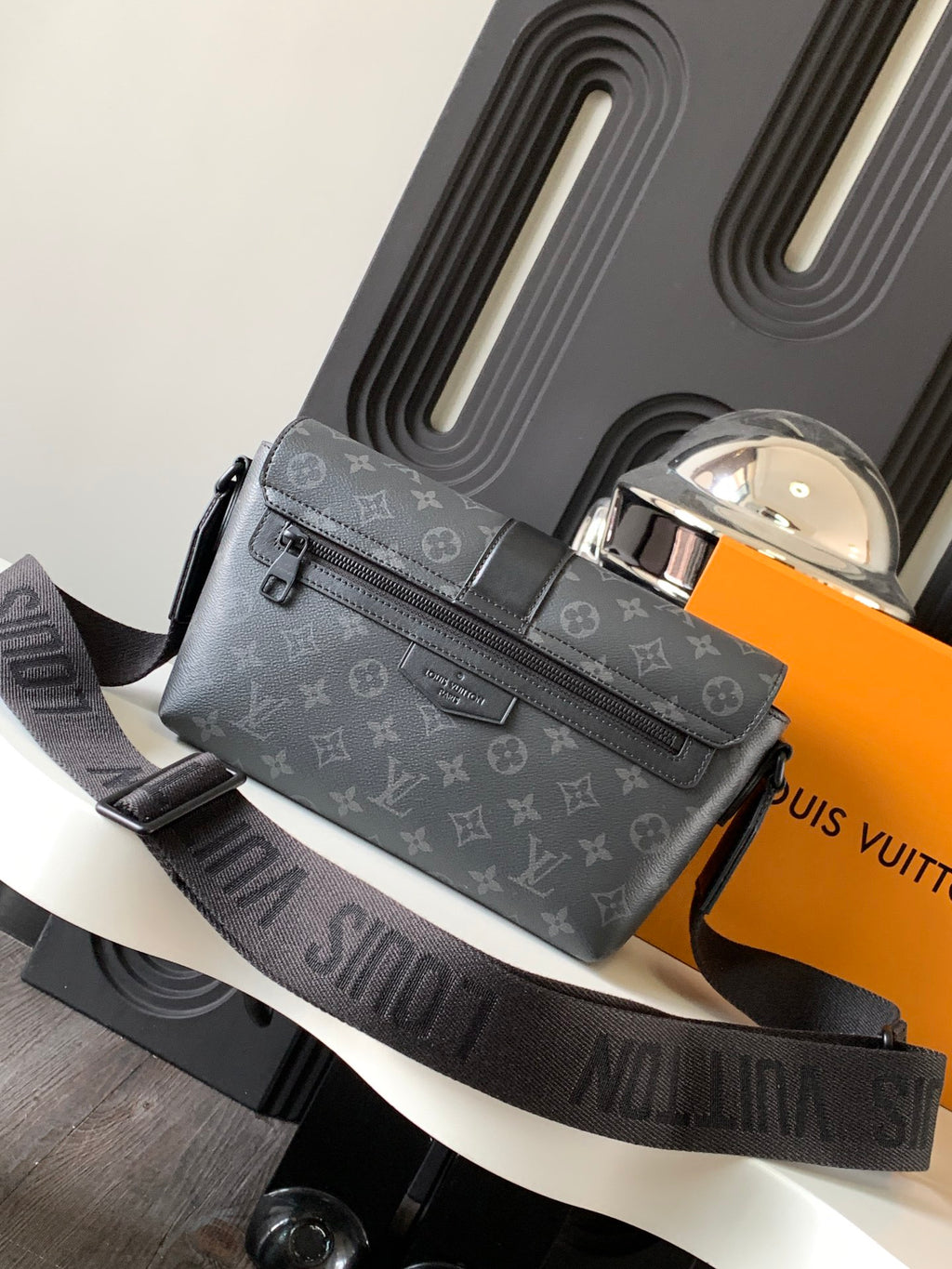 Louis Vuitton crossbody bag with zip front and flap, dark monogram canvas, adjustable strap.