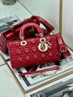 Dior red quilted handbag with top handles and adjustable shoulder strap