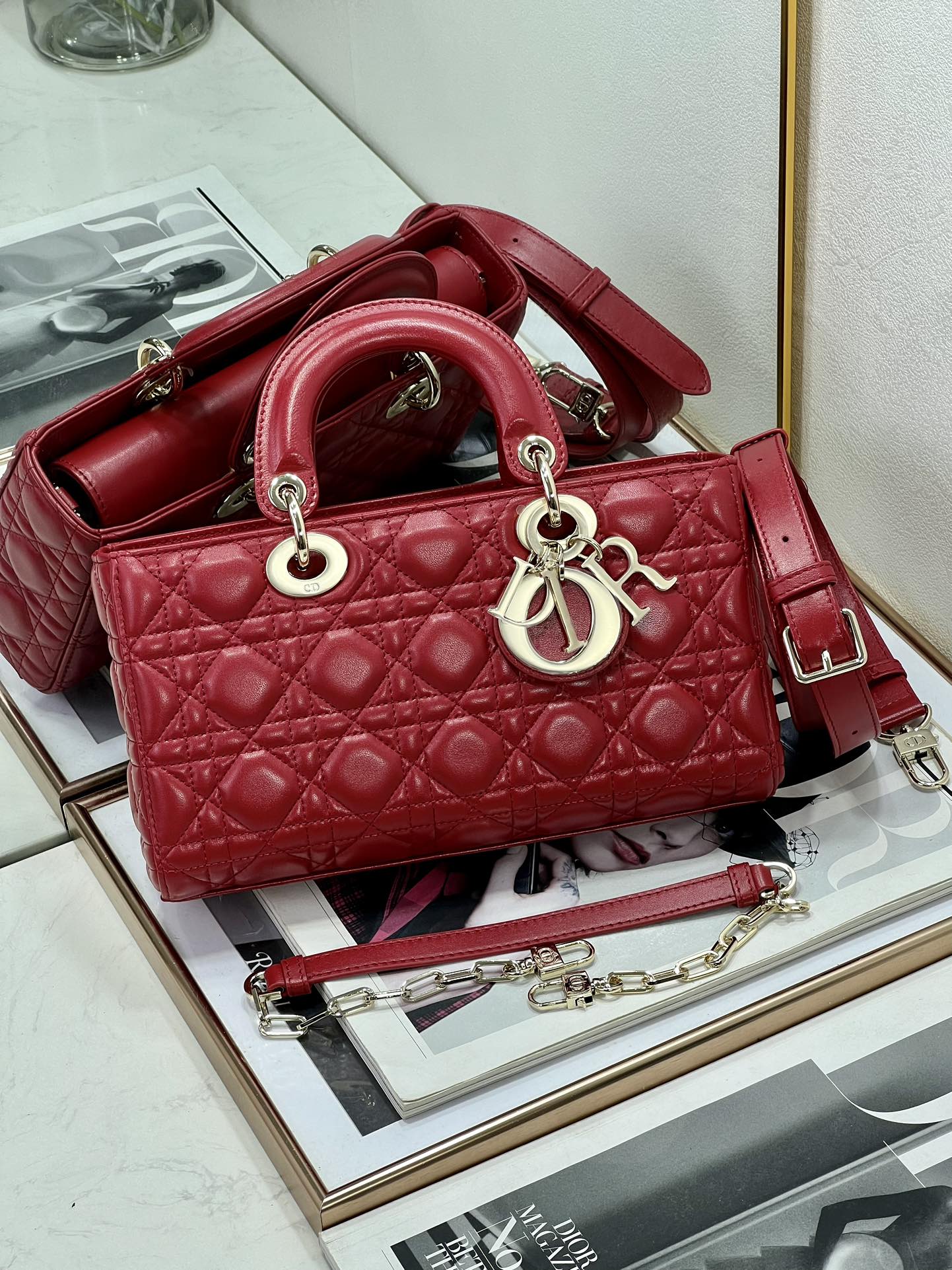 Dior red quilted handbag with top handles and adjustable shoulder strap