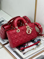 Dior red quilted handbag with curved top handles and crossbody strap