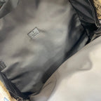 Gucci GG canvas backpack interior pocket with small white Gucci label patch