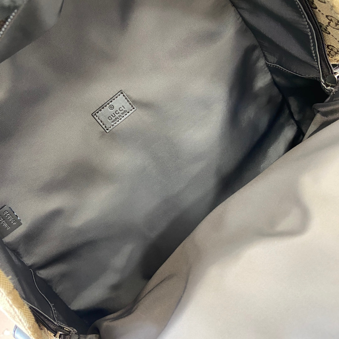 Gucci GG canvas backpack interior pocket with small white Gucci label patch