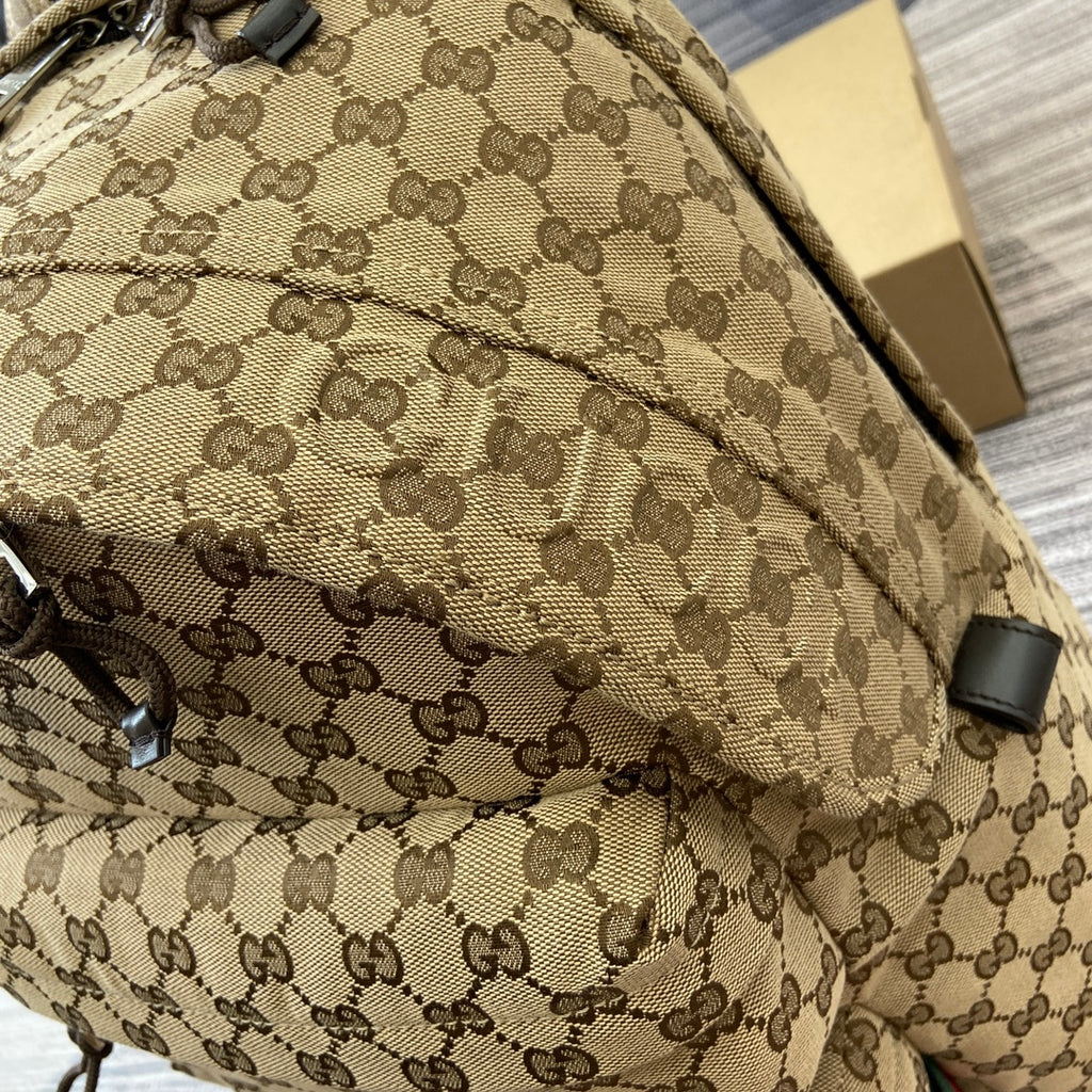 Gucci men's backpack side panel with GG monogram pattern and stitched trim