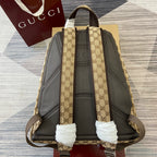 Gucci GG canvas backpack with padded gray back panel and adjustable shoulder straps