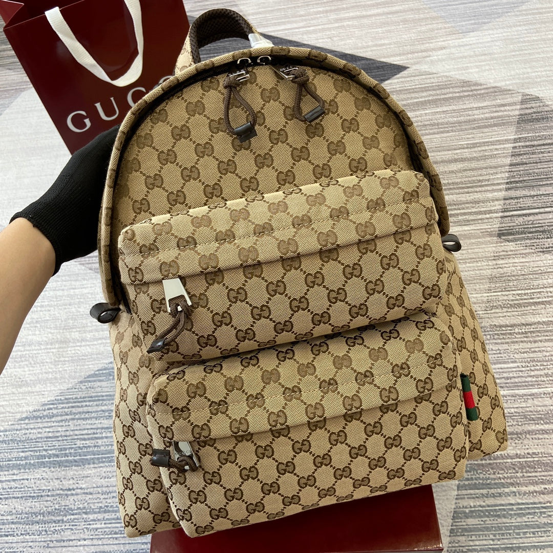 Gucci men's backpack front with tan GG monogram and top handle detail