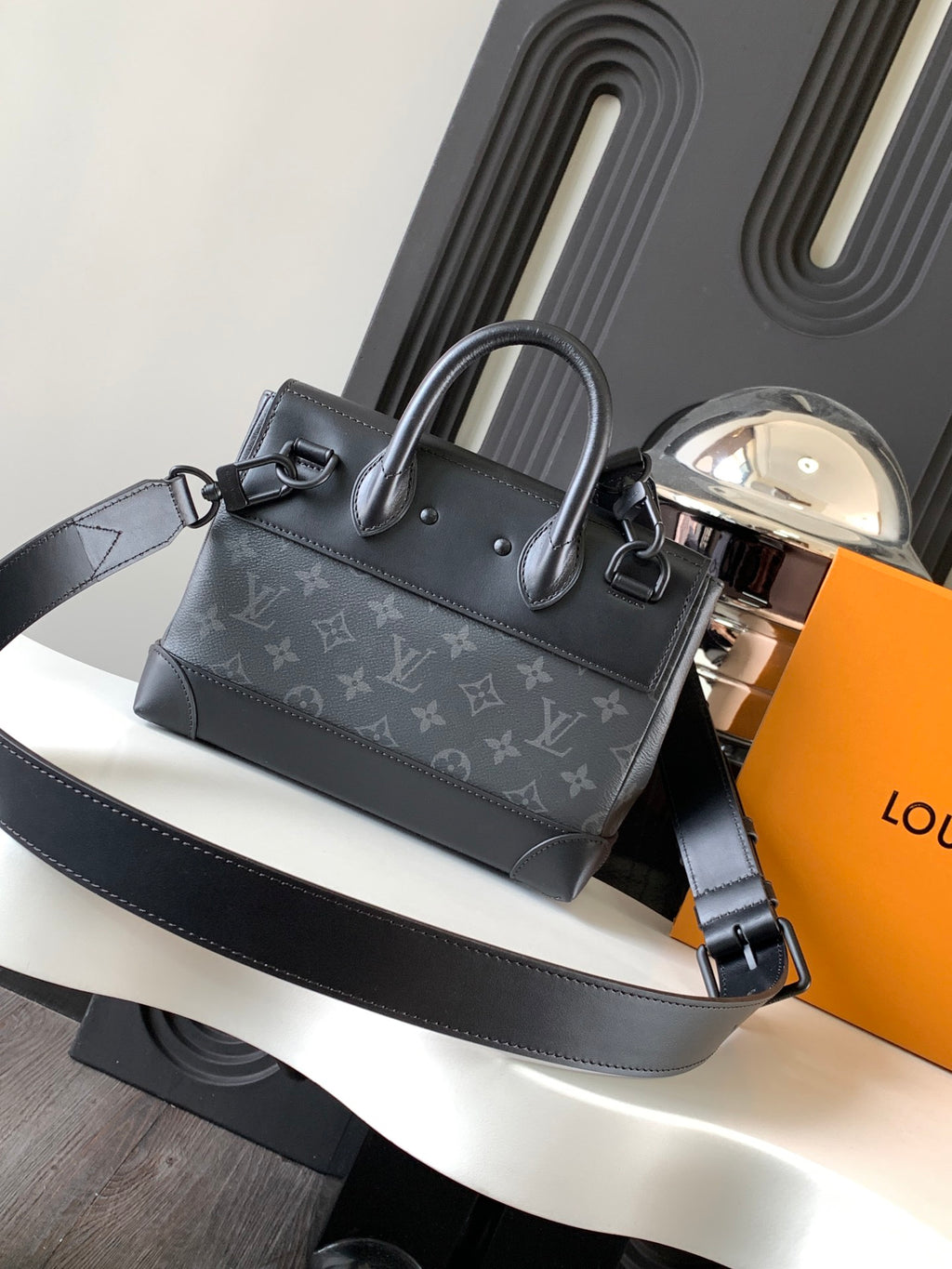 Louis Vuitton monogram handbag with top handle and shoulder strap, dark gray.