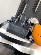 Louis Vuitton monogram handbag with top handle and shoulder strap, dark gray.