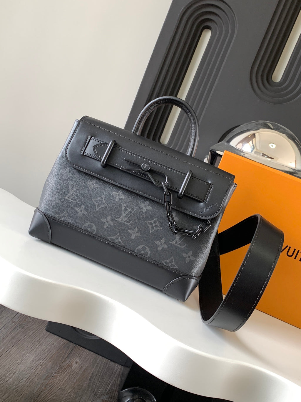 Louis Vuitton monogram handbag front view with top handle and shoulder strap, dark gray.