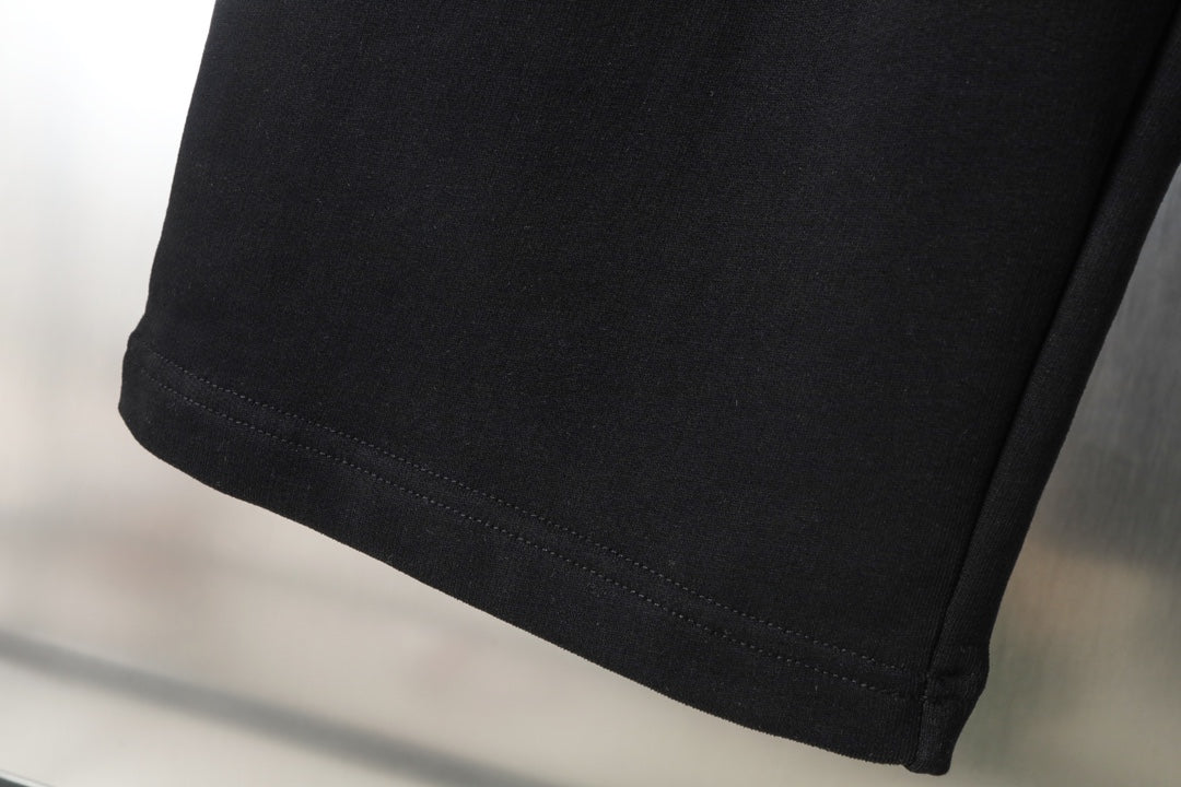 Black pants hem with stitched edge and side seam detail