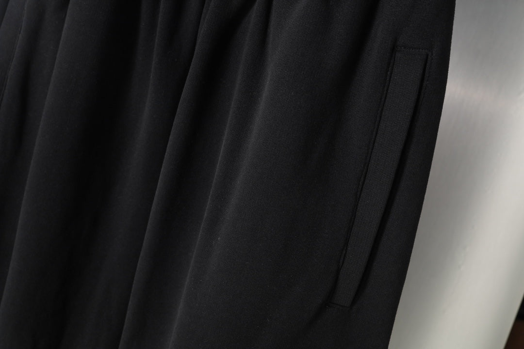 Black wide-leg pants with pleated front and visible seam line