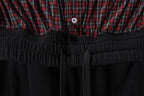 Black elastic waistband with plaid top band and small round logo button