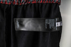 Black shorts interior size label with Balenciaga branding and barcode