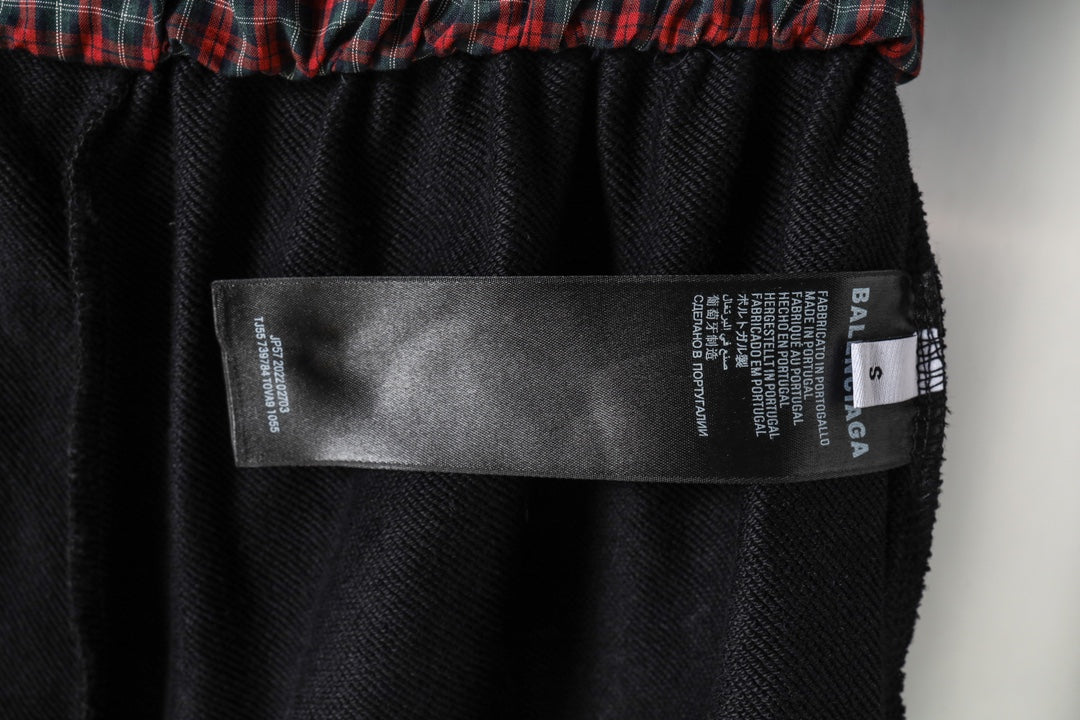 Black shorts interior size label with Balenciaga branding and barcode