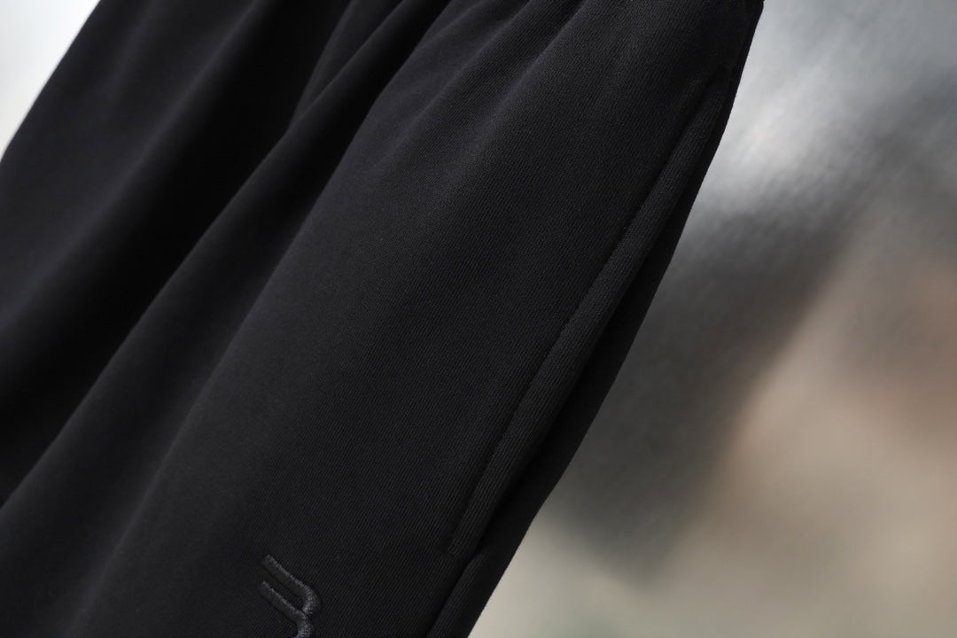 Black shorts with smooth drape fabric and side crease detail