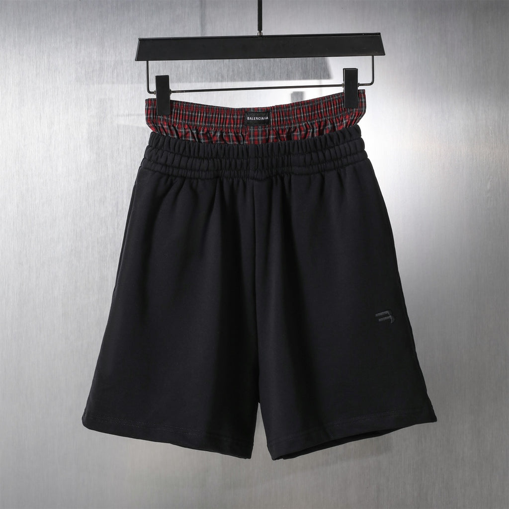 Black elastic-waist shorts with red plaid waistband trim