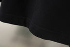 Black shorts hem with stitched edge and visible seam