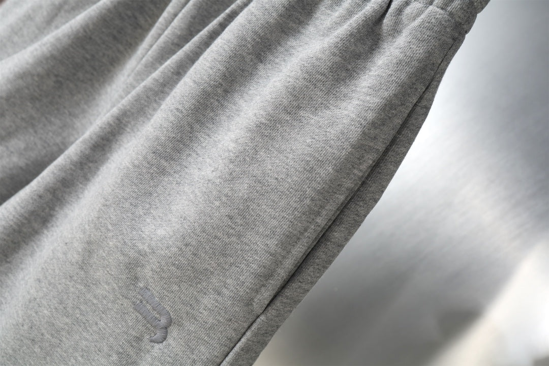 Grey knit shorts with diagonal side seam detail.