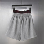 Balenciaga gray sweat shorts with elastic waistband and dark plaid inner band