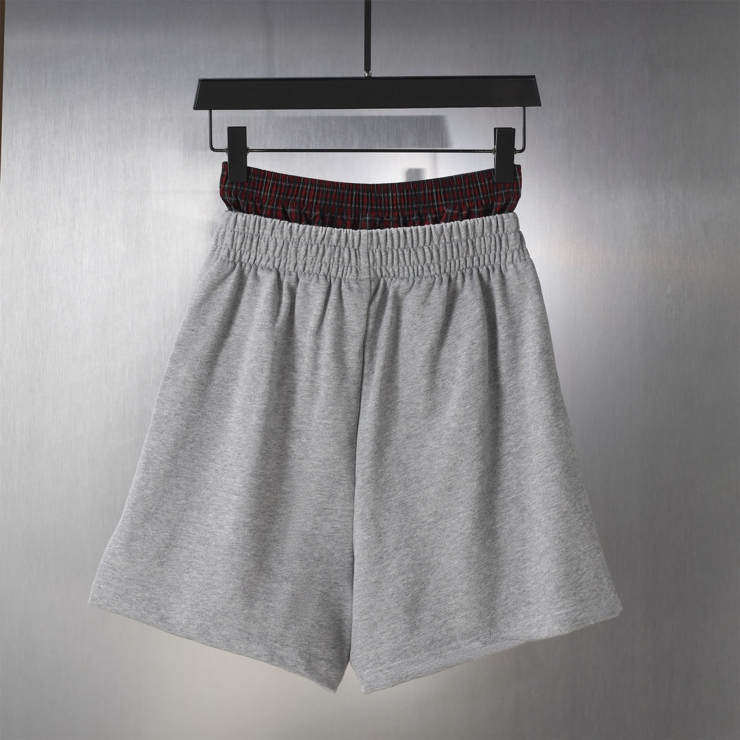 Grey fleece shorts with gathered elastic waist and red plaid trim, Balenciaga.