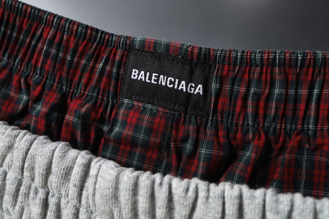 Balenciaga plaid waistband label on gray sweat shorts