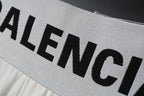 White waist band with large black Balenciaga lettering on sweat shorts