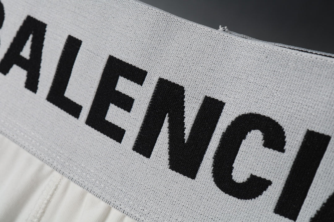White waist band with large black Balenciaga lettering on sweat shorts