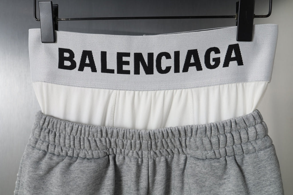 Gray shorts with BALENCIAGA logo across white waistband