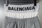 Gray shorts with BALENCIAGA logo across white waistband