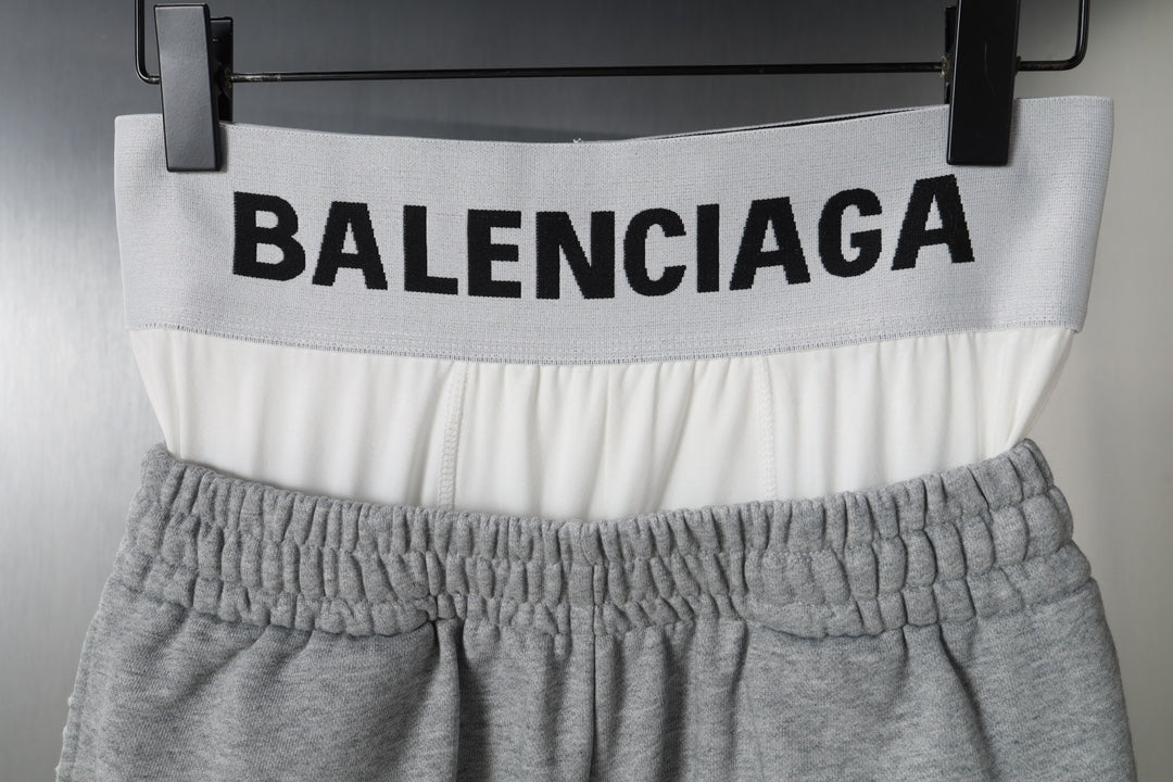 Gray shorts with BALENCIAGA logo across white waistband
