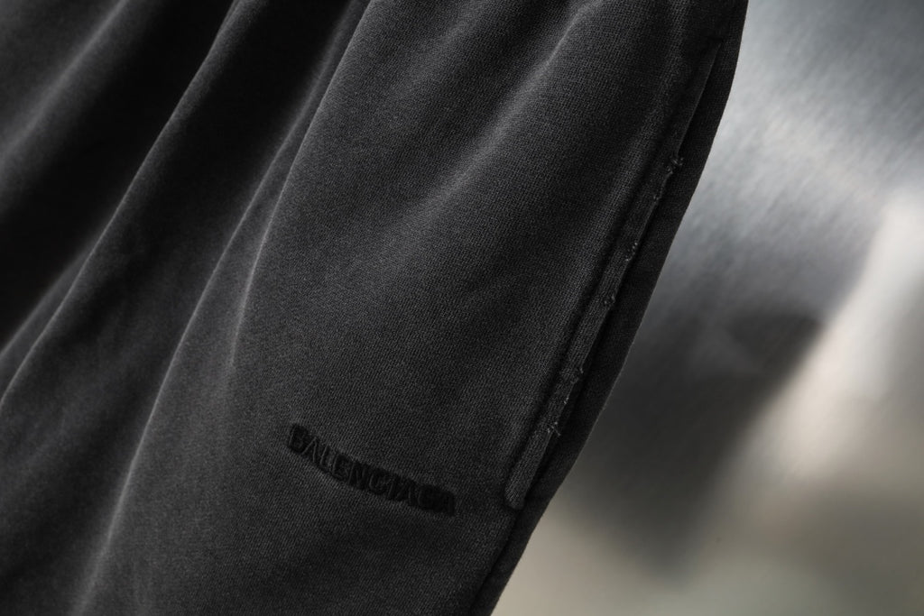 Black Balenciaga shorts side seam and small logo on leg, close-up