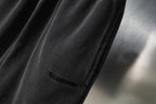 Black Balenciaga shorts side seam and small logo on leg, close-up