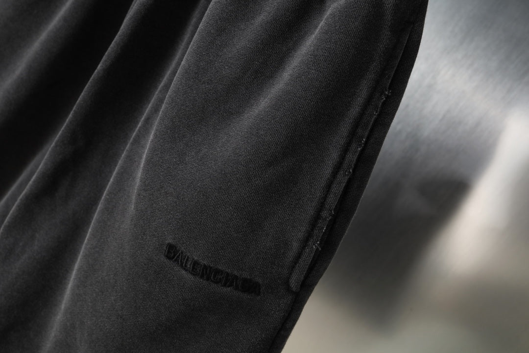 Black Balenciaga shorts side seam and small logo on leg, close-up