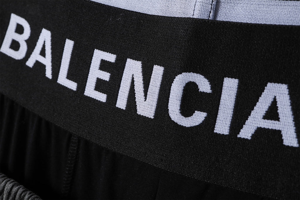 Balenciaga logo waistband on black shorts, close-up of printed lettering