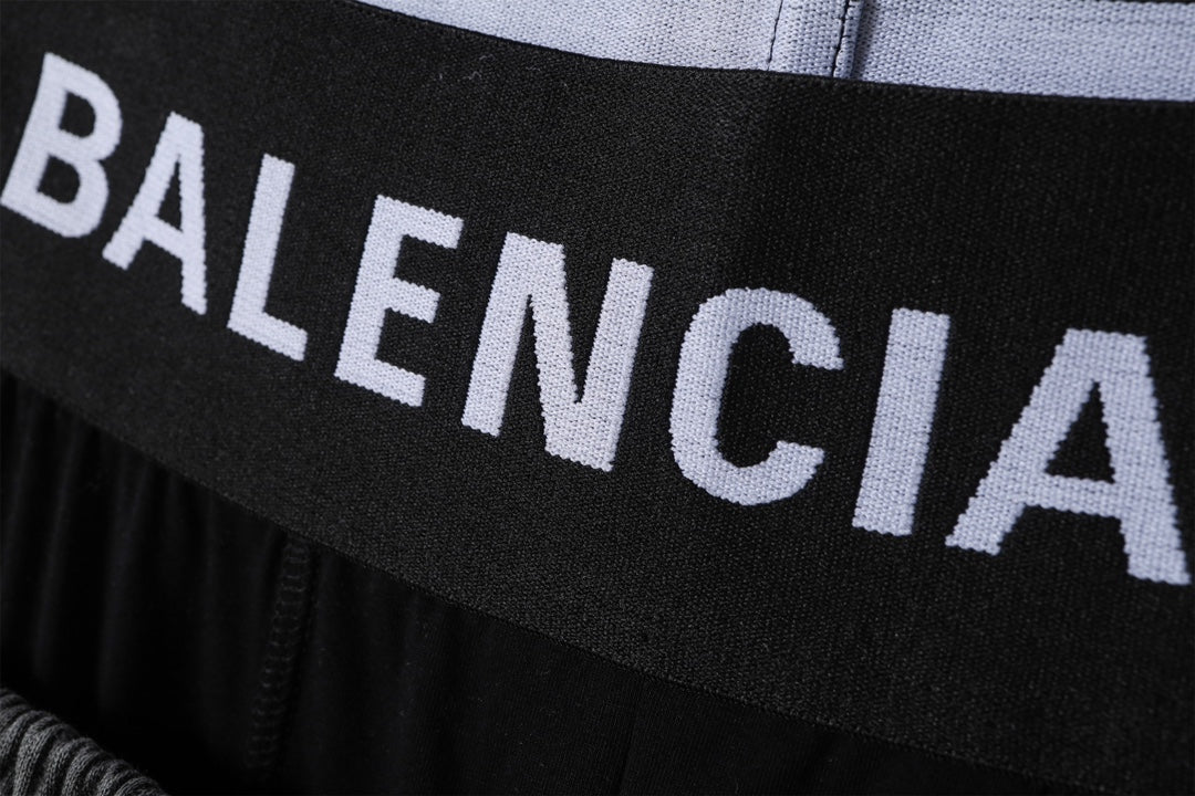 Balenciaga logo waistband on black shorts, close-up of printed lettering