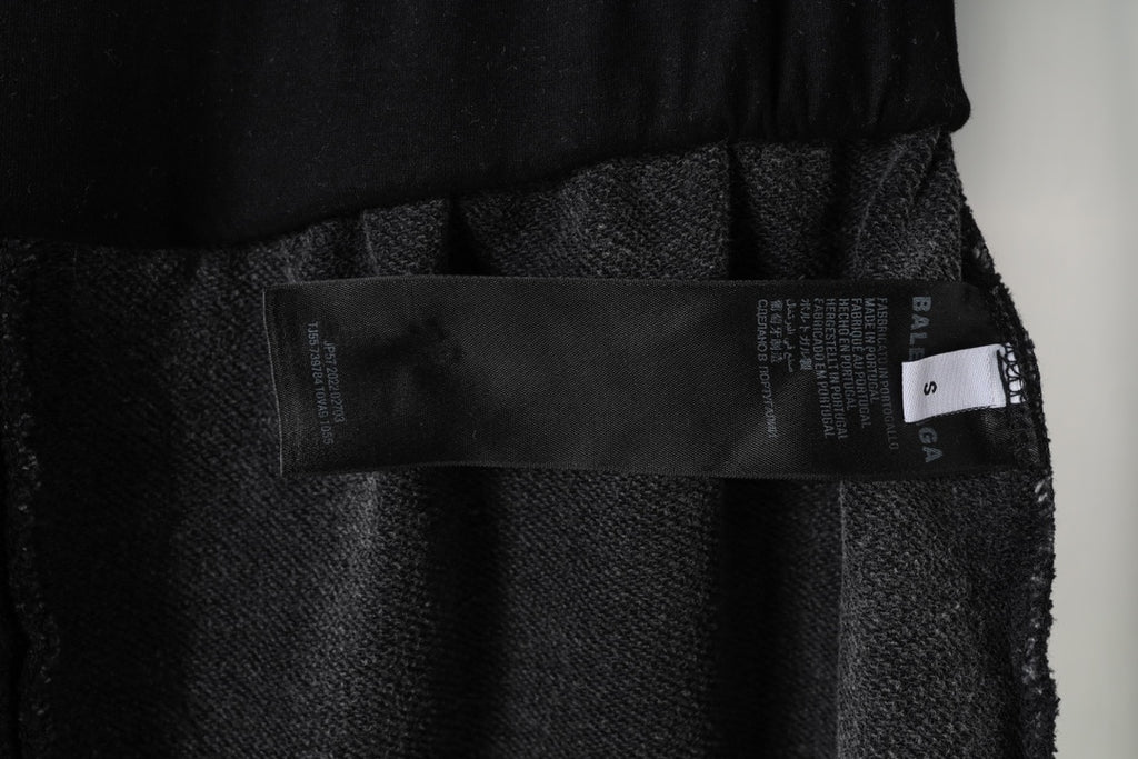 Black Balenciaga shorts inner tag and fabric label near waistband, close-up
