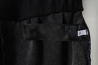 Black Balenciaga shorts inner tag and fabric label near waistband, close-up