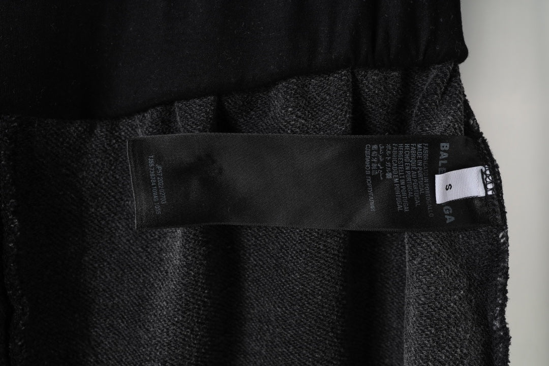Black Balenciaga shorts inner tag and fabric label near waistband, close-up