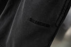 Black Balenciaga shorts leg with small stitched logo near hem, close-up