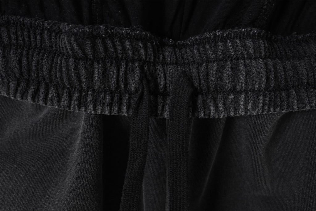Elastic waistband detail on black Balenciaga shorts, close-up